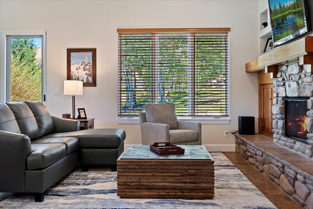 Let the natural light pour in as you relax fireside—your perfect spot for morning coffee or winding down at night.