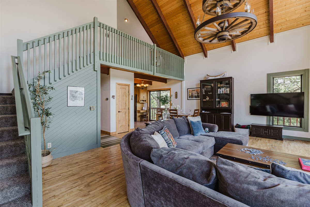 Relax in the open living room, where soaring windows frame stunning mountain views and fill the space with natural light.