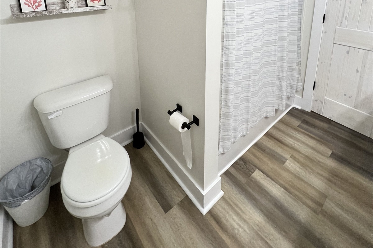 This full bathroom with a tub/shower combo is shared by bedrooms 2 and 3.