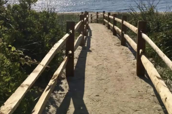 This scenic sandy path with rustic wooden railings leads you directly to the beach. It provides a short and easy walk from the property to the beautiful shoreline and ocean waves.