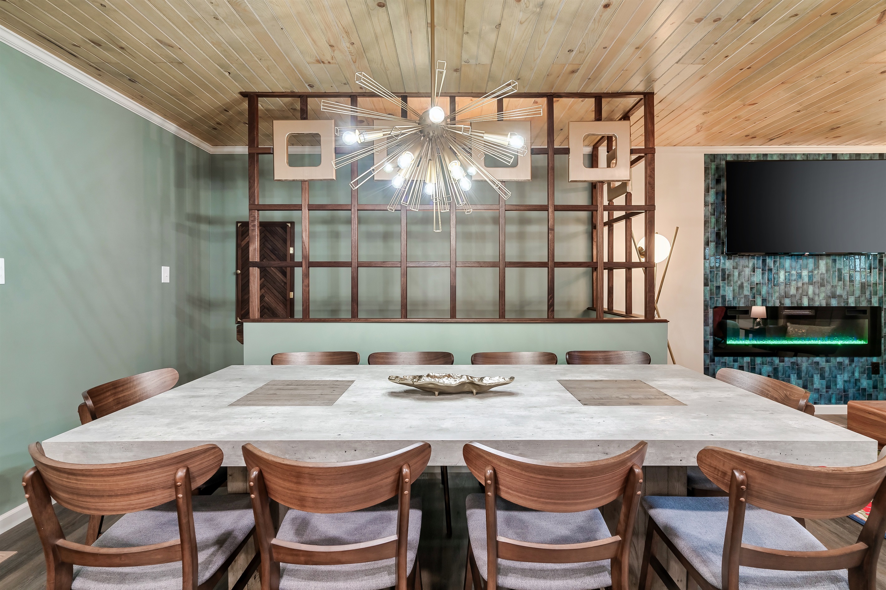 Mid-Century Modern masterpiece! The striking Sputnik chandelier and the beautiful wood-slat room divider make this space shine.