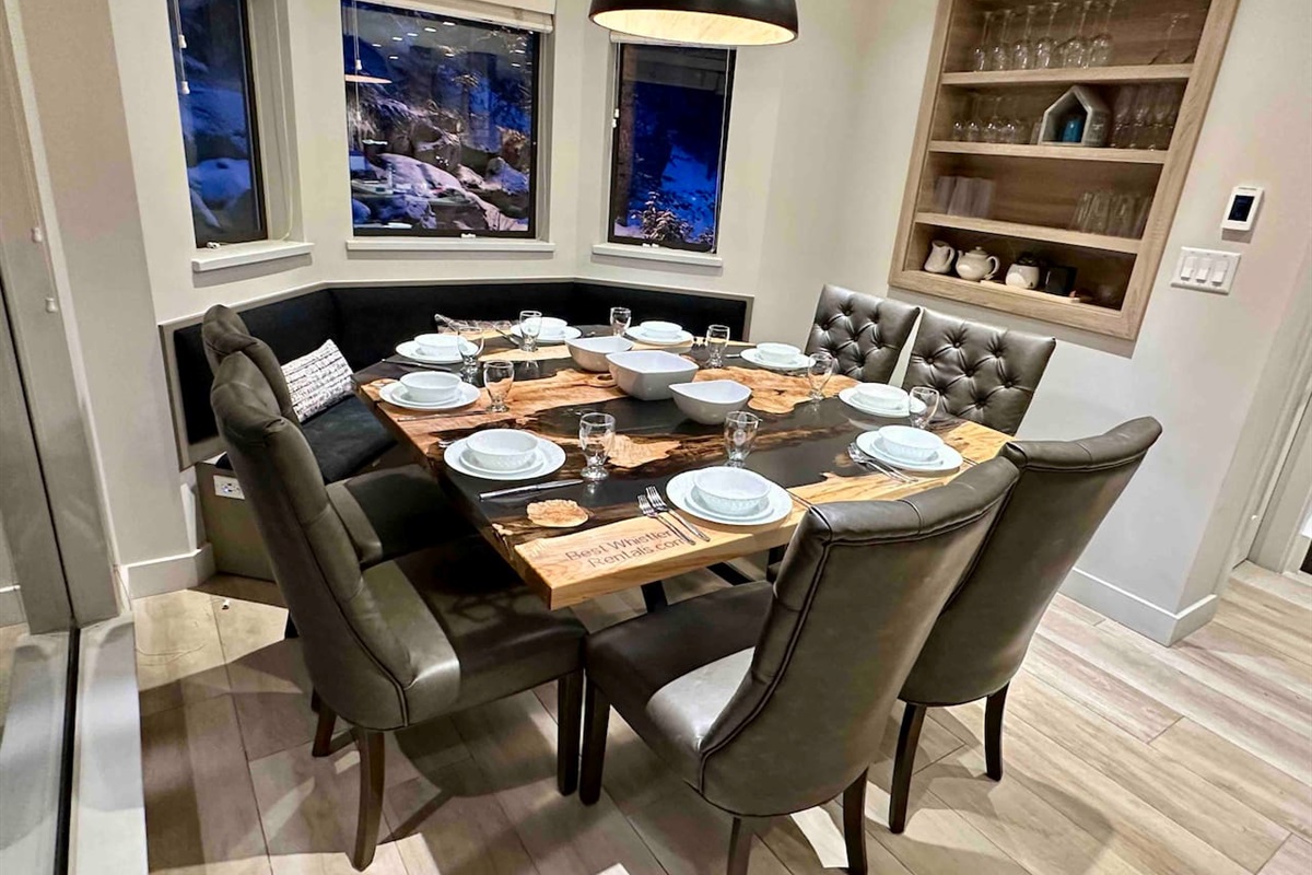 Custom designed live edge maple dining table with build in bench optimizes seating for upto 10 people. Wine glasses, dinnerware for 10ppl.  Patio access from dining area.  Whistler Upper Village a short 2min stroll. Walk to everything, ski-on/ski off