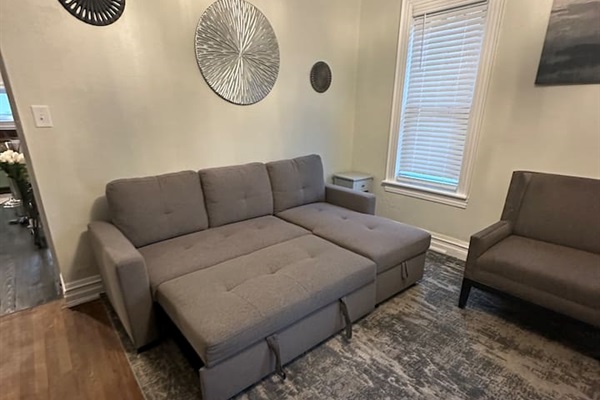 extra bedding and pillows stored under chaise 