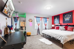 Master Bedroom: A serene retreat of comfort and style, featuring a luxurious king-sized bed, striking red accent walls, and captivating artwork that blends creativity with relaxation.