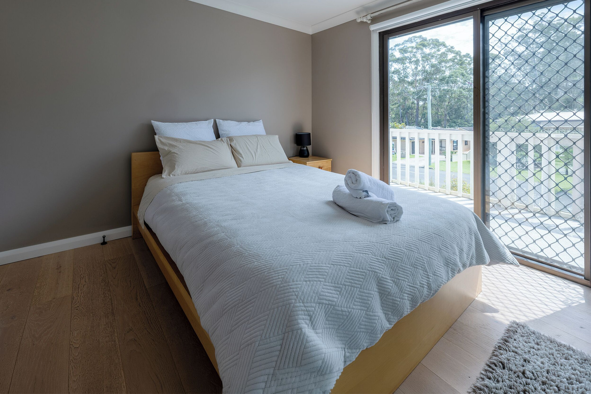 Natural light, balcony doors and leafy outlooks give this Luna’s Sanctuary bedroom a calm, open feel for slower mornings.
