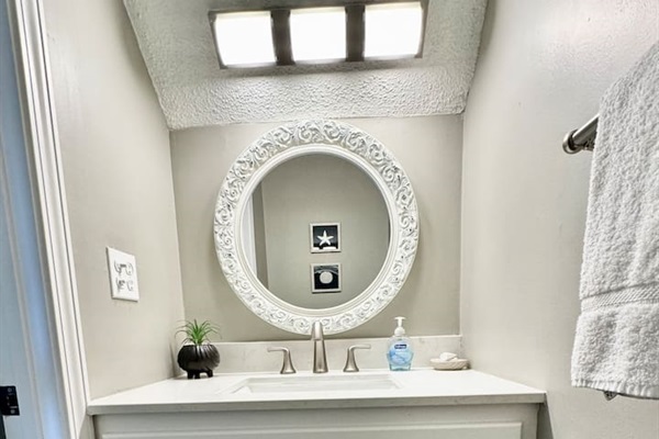 Bathroom Retreat: Bright mirror and sleek fixtures create a refreshing space to unwind!