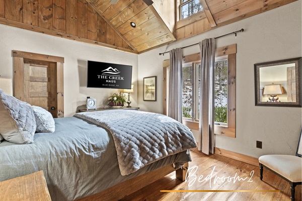 Bedroom 2: This inviting queen bedroom offers soft linens, natural light, and tranquil views, making it the perfect spot to recharge after a day of adventure