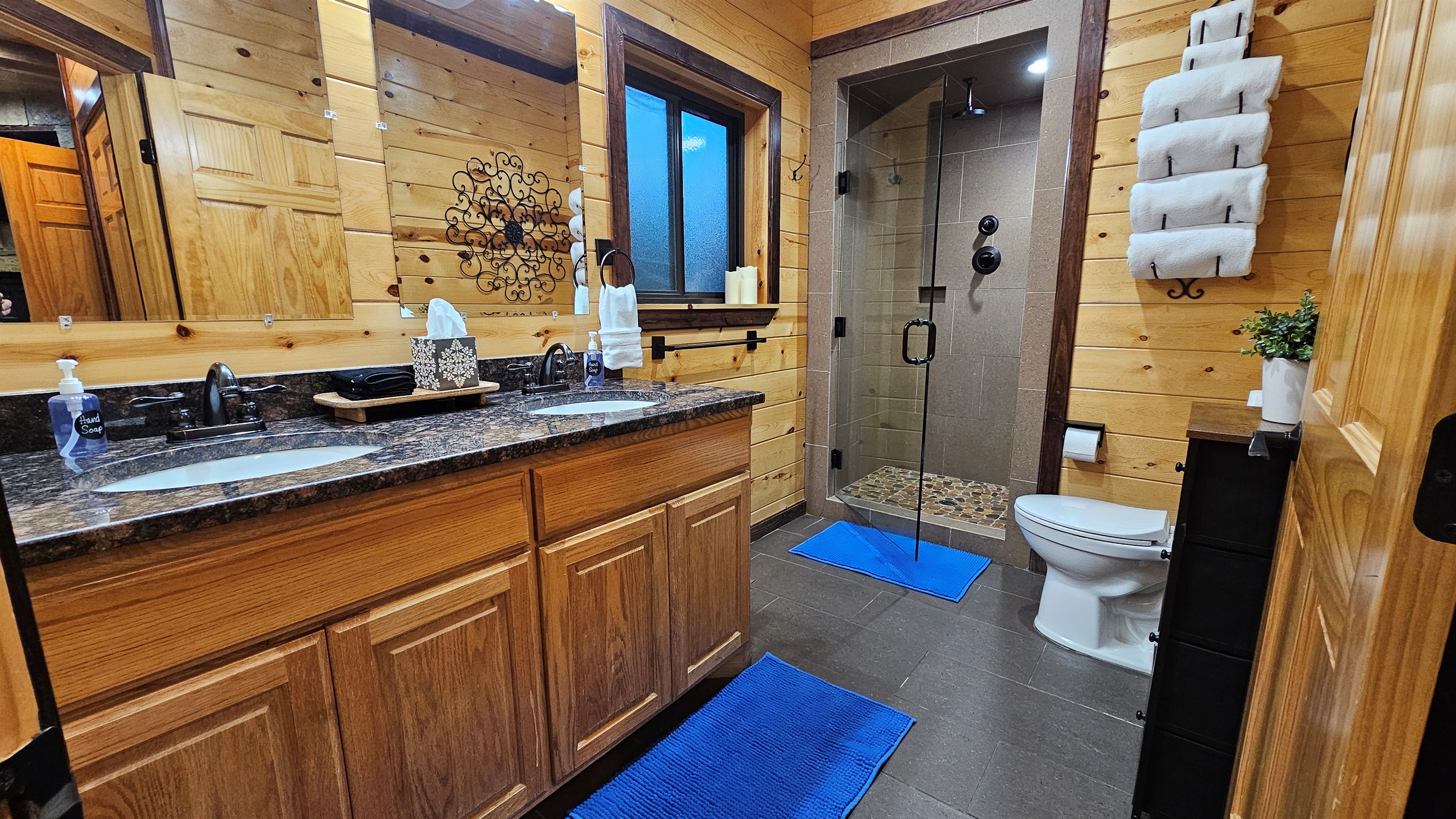 Enjoy a touch of luxury in the spacious primary bathroom featuring a double vanity and a walk-in rain shower.