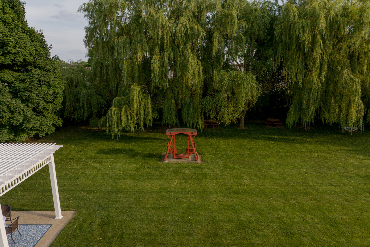 Relax beneath the shade of majestic weeping willow trees while enjoying peaceful garden views, comfortable seating areas, and fresh Lake Erie breezes