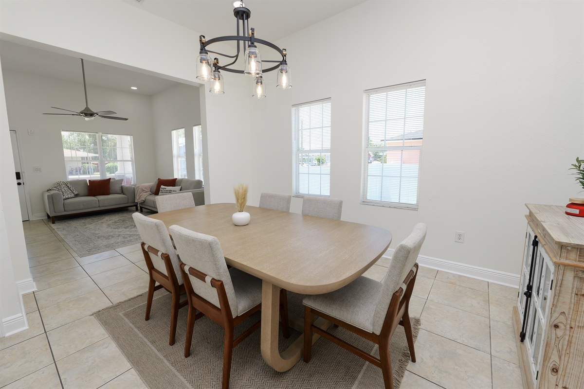 Comfort meets elegance in this dining area, where soft neutral tones and a statement light fixture create the perfect mood for every meal.