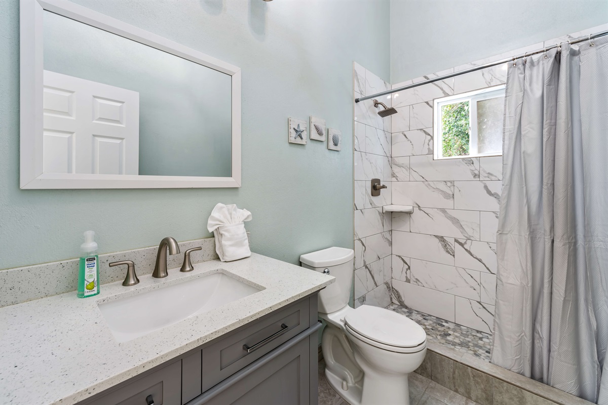 Bright and spotless bathroom for freshening up after beach adventures.