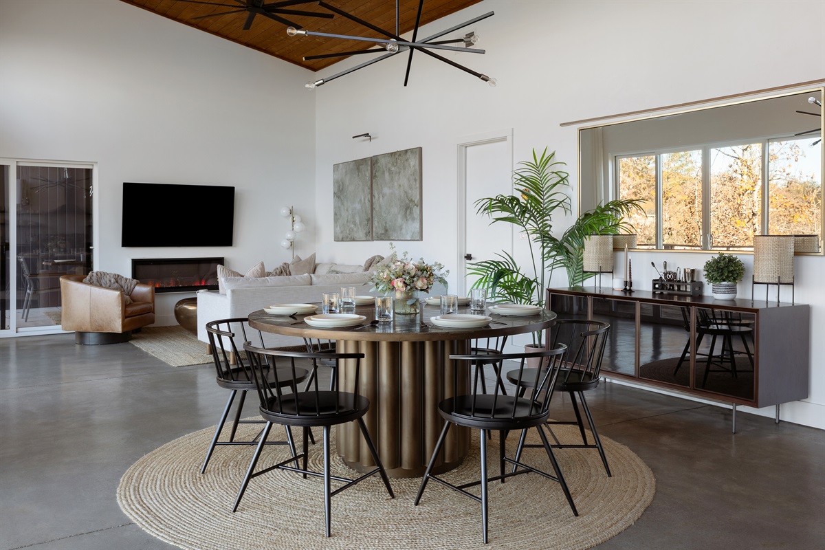 {Glass House Dining} A dramatic round dining table and warm modern design invite everyone to sit, share, and slow down