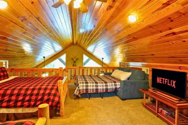 Loft sleeping area with 2 full beds + sleeper sofa — flexible sleeping for larger groups.