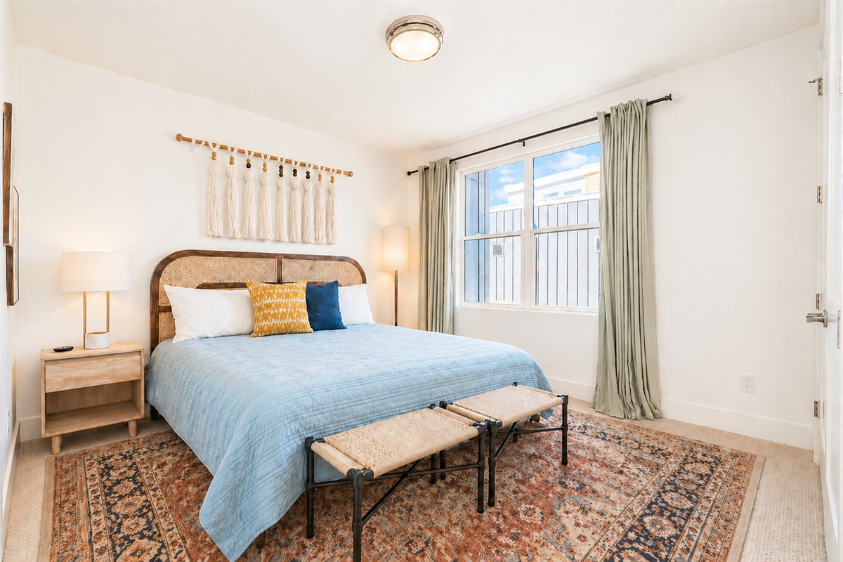 This 3rd floor king bedroom has an ensuite bathroom attached. Draw the curtains for privacy, and open up your double closet doors to watch TV from bed! 