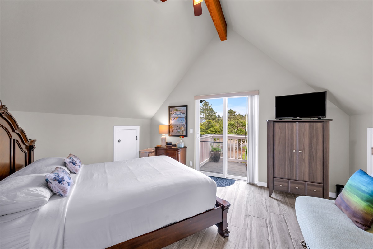 Upstairs back bedroom with queen bed, full-sized Euro lounger, armoire, and 30" SmartTV/cable