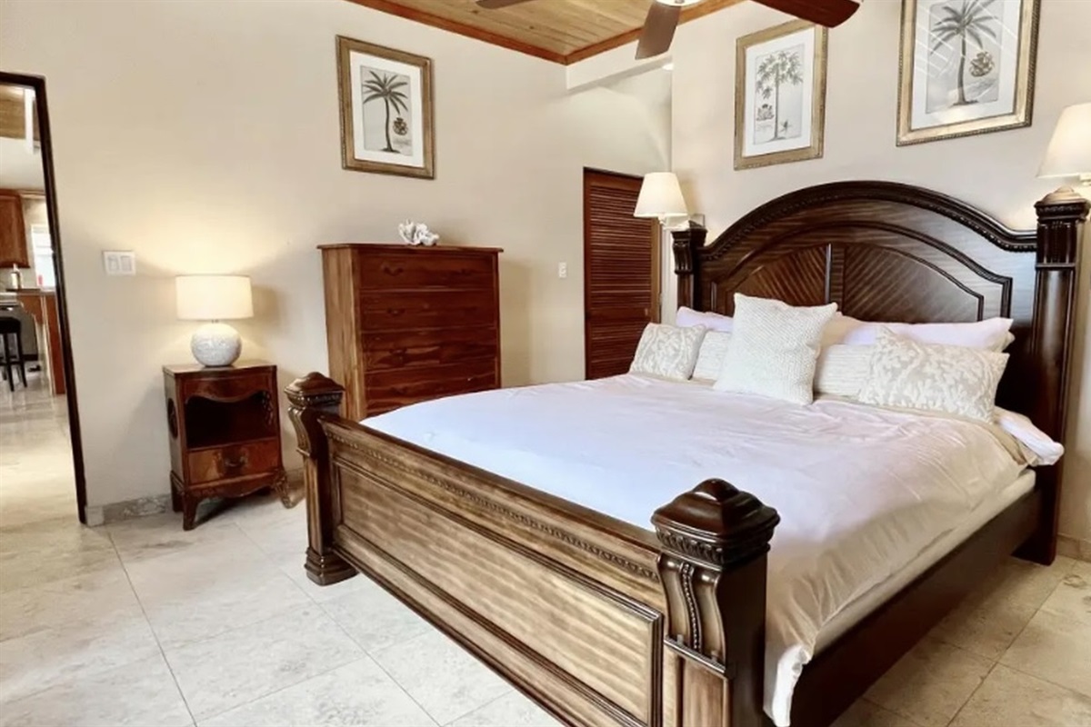 Relax in the king primary suite with elegant furnishings and calming Caribbean style.