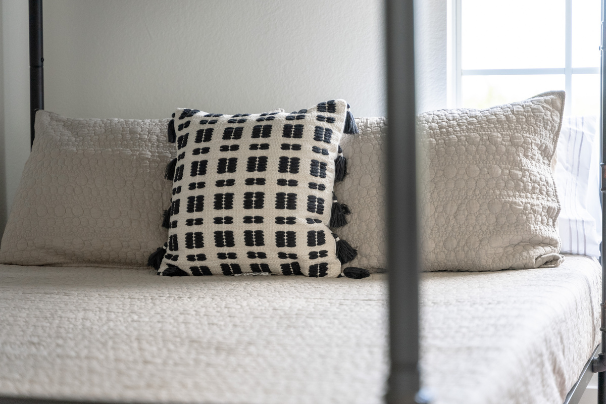 Buffalo-check pillows bring cozy, cabin-style charm to this bunk room