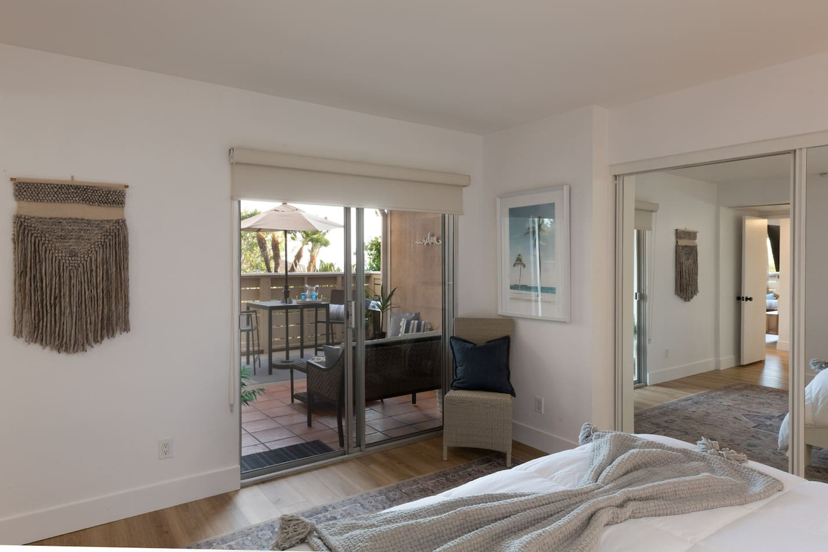 Enjoy the ocean breeze from the patio sliders in this master bedroom 