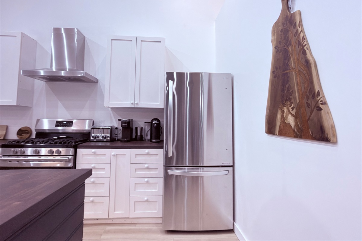 Kitchen with gas range and full-size stainless refrigerator