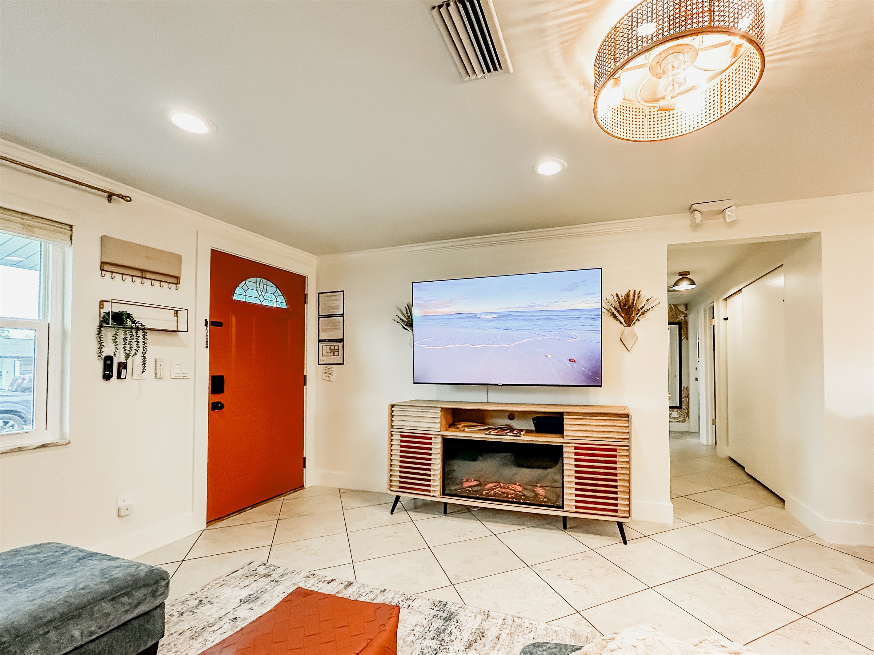 Living Room with Couch, 65" Roku TV, Indoor Electric LED Fire Place, & Fandelier