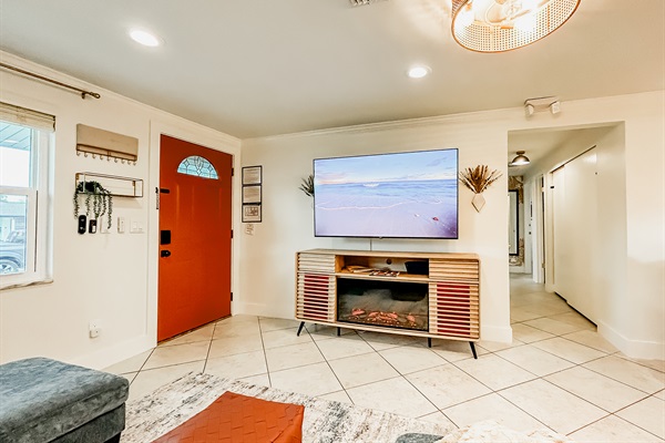 Living Room with Couch, 65" Roku TV, Indoor Electric LED Fire Place, & Fandelier