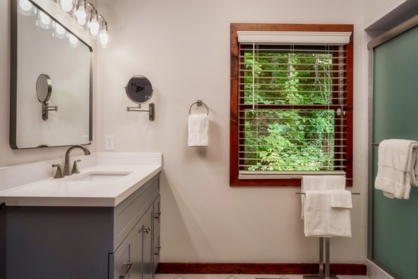 Private ensuite bathroom with modern touches and forest views.