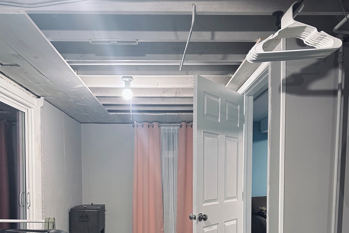 Entry to the lower-level office & living suite from the unfinished portion of the basement. Set apart from the main living areas, creating a peaceful, distraction-free environment perfect for remote work.