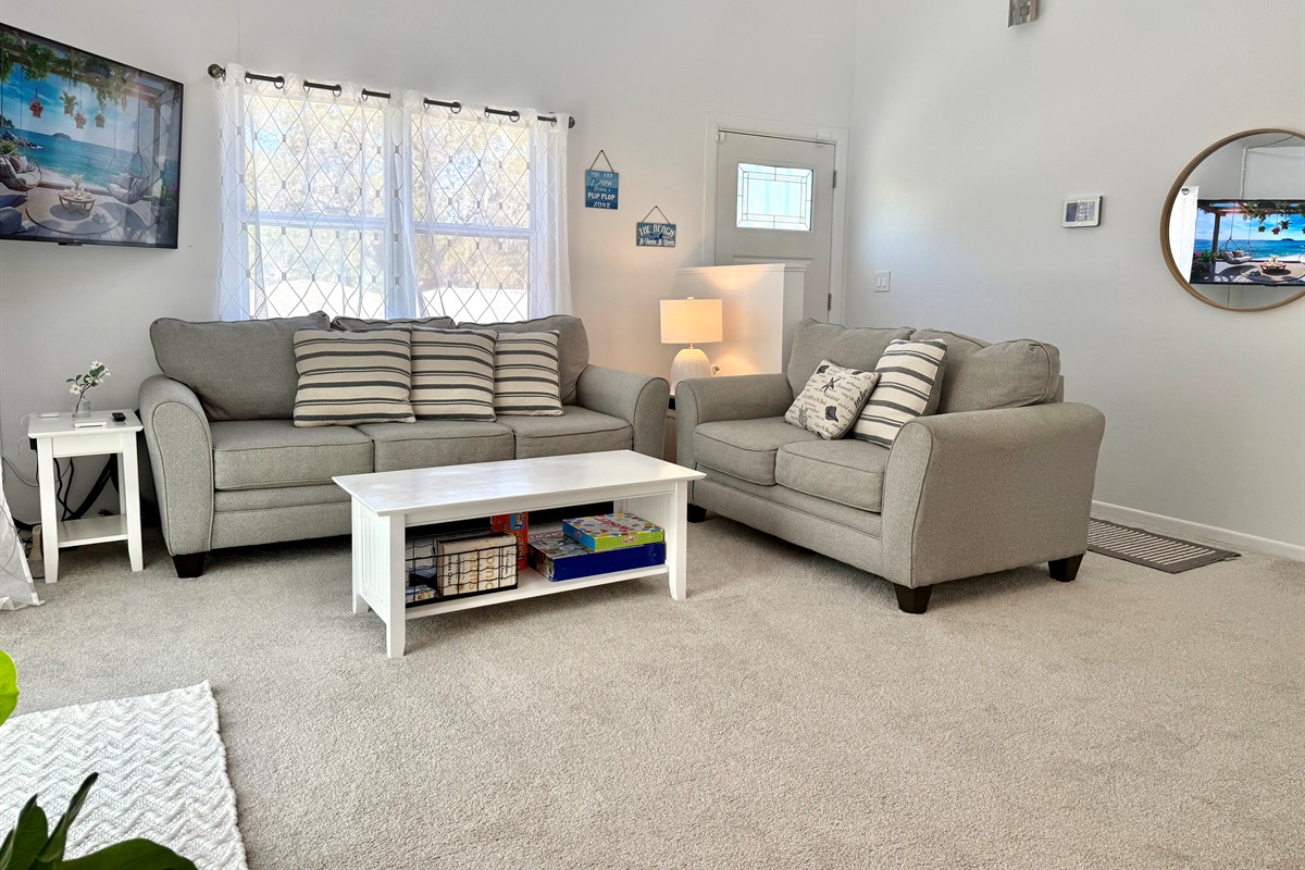 Unwind on the plush sectional sofa, enjoy a favorite show on the flat-screen TV, or simply soak up the calming atmosphere of this cozy space.