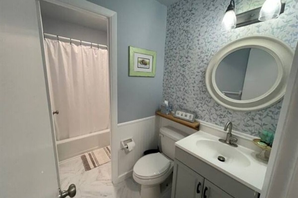 1/2 bath off hallway. This 1/2 bath is also connected to the tub & shower room.