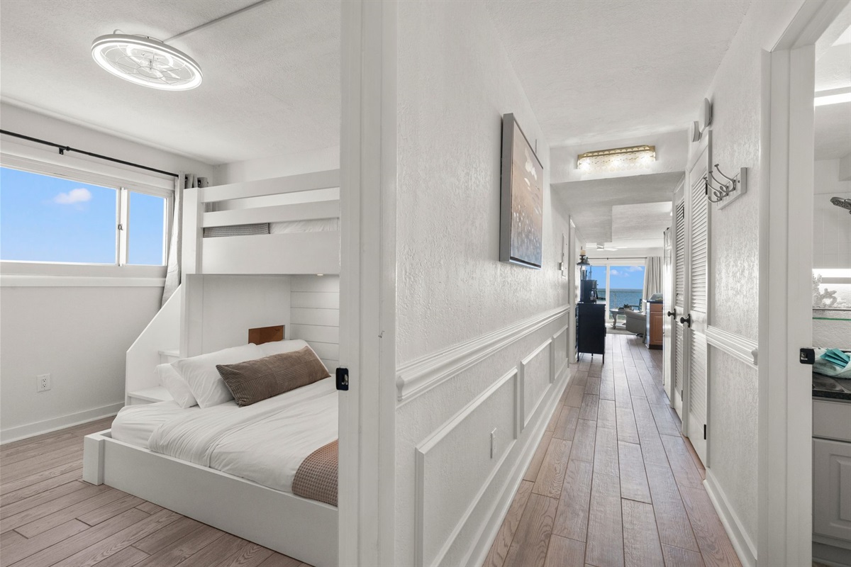 As you step into Summit Serenity, you’ll find the guest bedroom just to the left—featuring custom-built adult bunk beds designed for comfort and space. The setup includes a queen on the bottom and a Twin XL on the top, making it perfect for families, frien