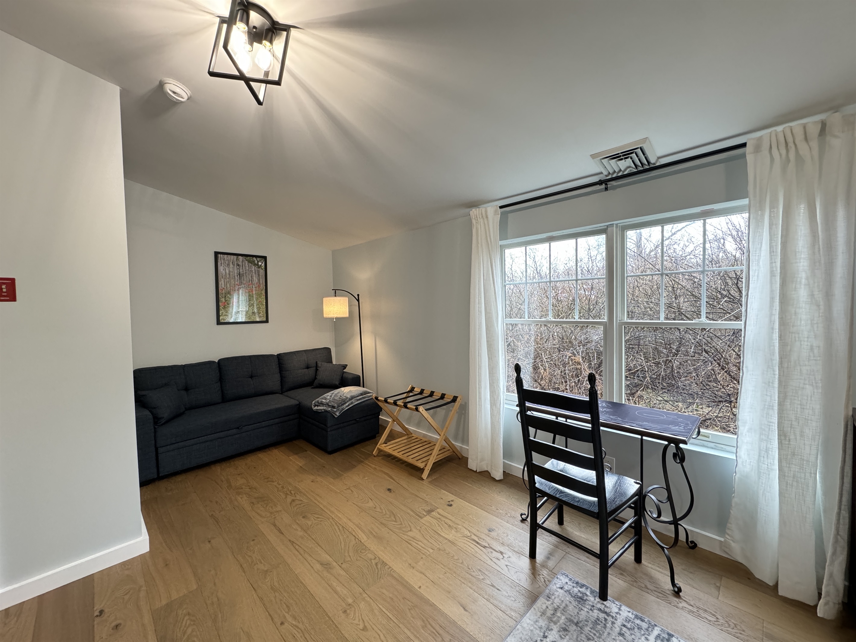 Primary Queen bedroom with desk and lounge area