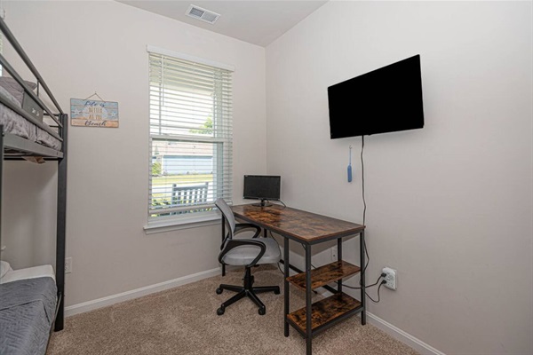Step into our functional third bedroom! Discover a spacious desk and a wall-mounted smart TV, perfect for work and entertainment. With a double queen bunk bed, it's a dynamic space for both relaxation and productivity. ️️