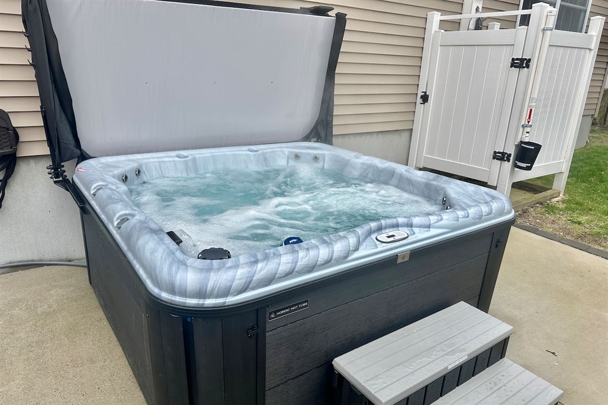 Enjoy a relaxing soak in the bubbling hot tub after a day of adventure. This private outdoor amenity features easy-step access and is situated right next to a convenient outdoor shower for a quick rinse before or after a dip.