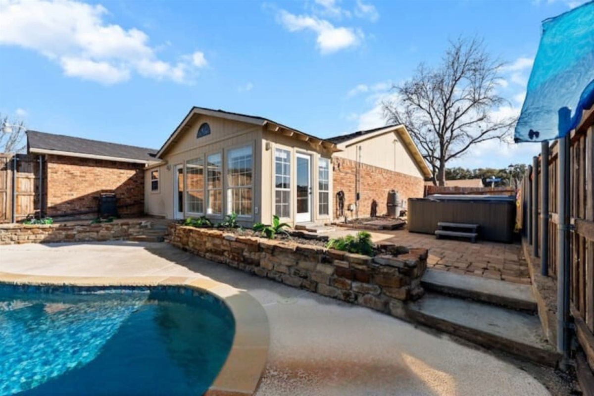 Private backyard oasis with sparkling pool, sun loungers, and direct access to the indoor bar—perfect for poolside entertaining.