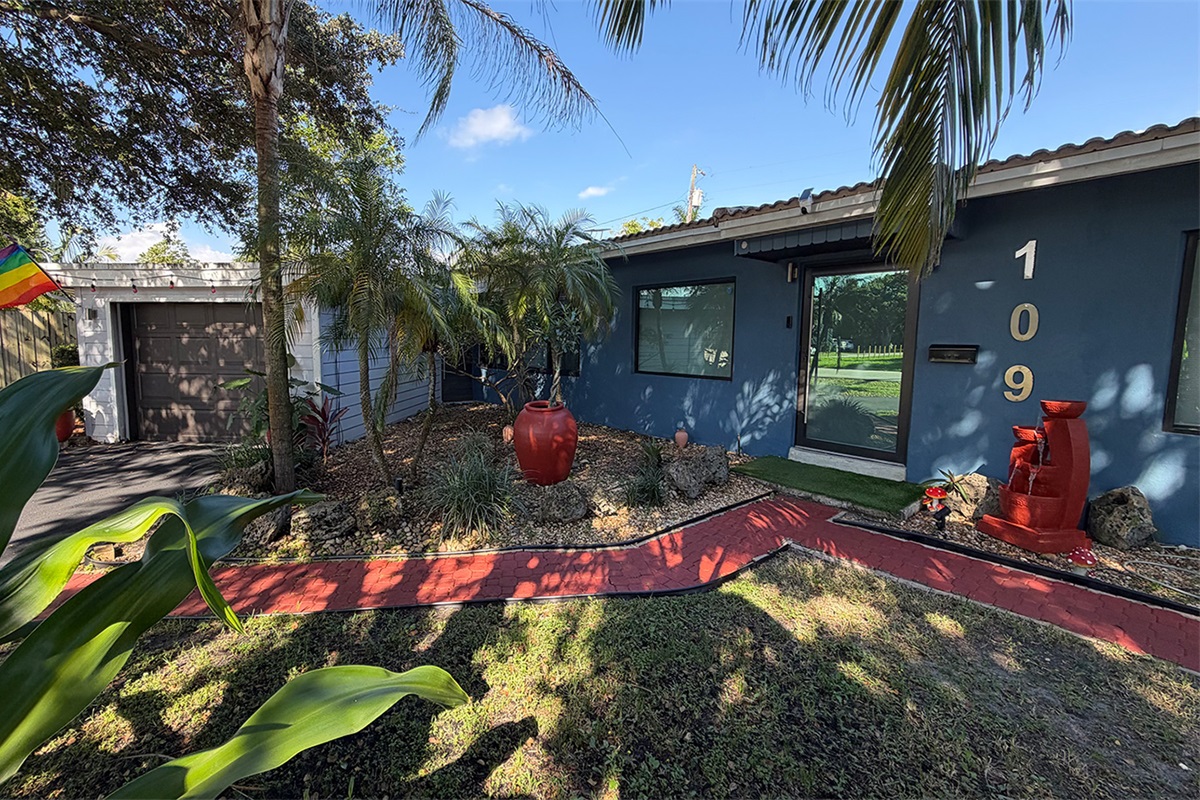 A landscaped garden walkway at Garden of Manors, blending color, greenery, and boutique design details.