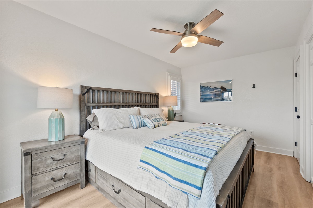 Queen bedroom with a cozy setup and soft coastal touches.
