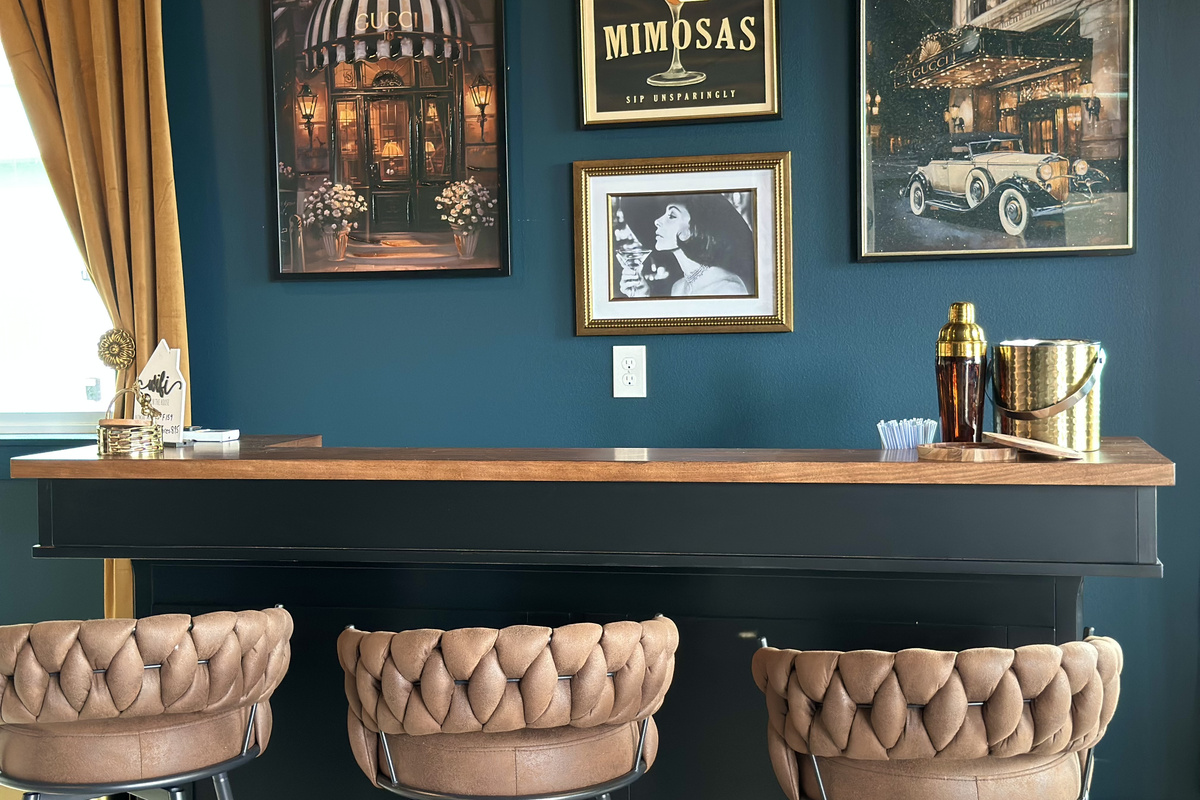 Shaker, ice bucket and a gallery wall of vintage prints — the Speak Easy is set for happy hour downstairs while the main level stays calm.