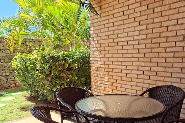 Enjoy a meal under the sun with a comfortable outdoor dining setup.
