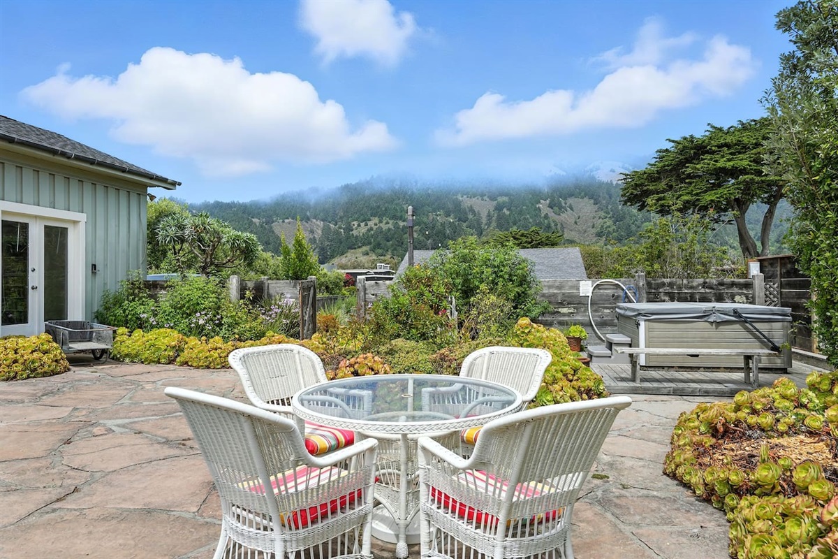 - Patio dining area with mountain views and beautiful garden surroundings  
- Glass top table with cushioned chairs offers comfort for outdoor meals  
- Peaceful retreat perfect for enjoying the natural scenery and fresh air  
