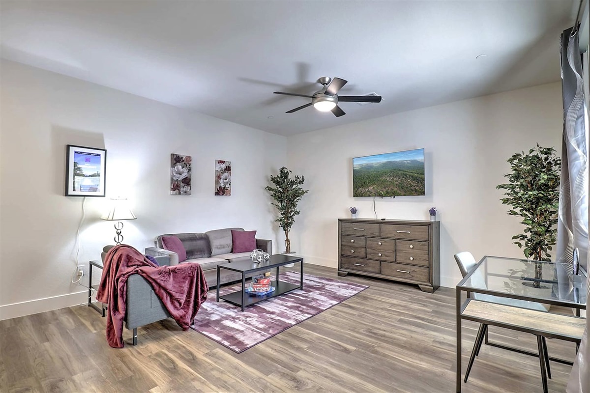 - Relax in a spacious living area with stylish decor, smart TV, and cozy seating   - Natural light fills the room with elegant touches and a calming atmosphere   - Great for lounging, dining, or catching up after exploring nearby attractions