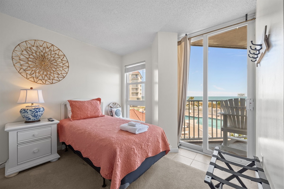 Bright guest room with balcony access and ocean views just steps away