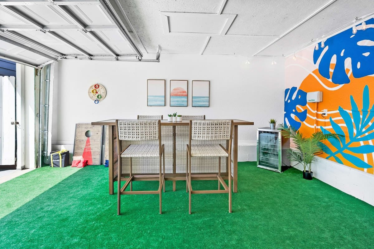 The full length of the tiki lounge, bar at one end and sofas at the other. Cornhole, darts and lawn games are all here, which covers both the competitive members of the party and the ones who just watch.