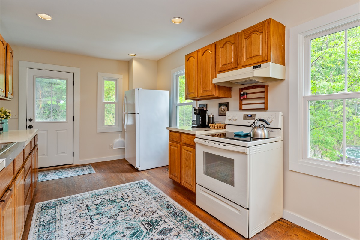 Spacious galley kitchen featuring ample counter space, updated appliances, and plenty of storage, ideal for cooking and entertaining.