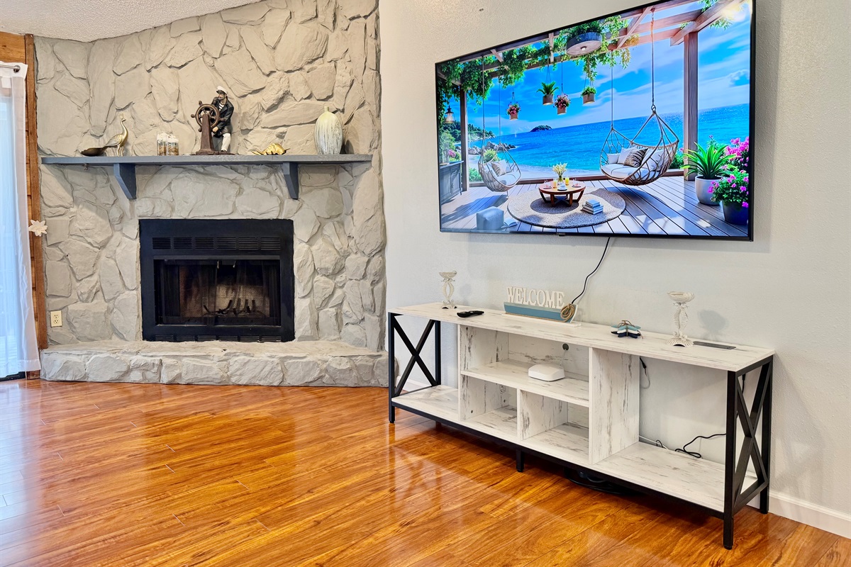 Anchoring the room is a stunning floor-to-ceiling stone fireplace, creating a rustic focal point that exudes coziness and character.