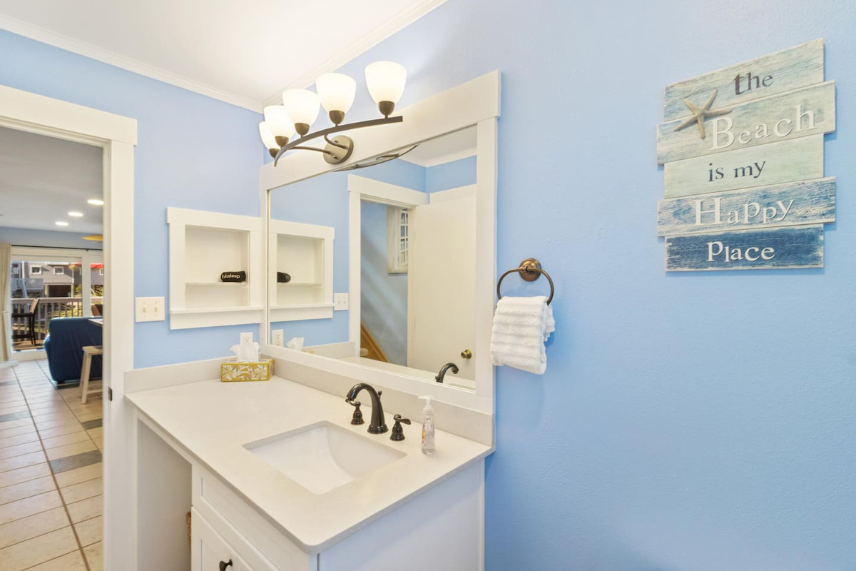 Your updated main-level guest bath is fresh and convenient &mdash; a second full bathroom for busy mornings and sandy afternoons.