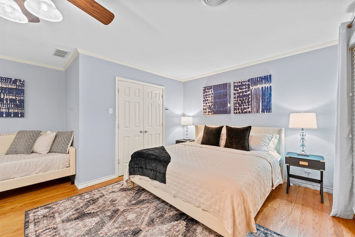Retreat to a luxurious king bedroom with soft lighting, calming tones, and a bonus daybed for extra guests or lounging.