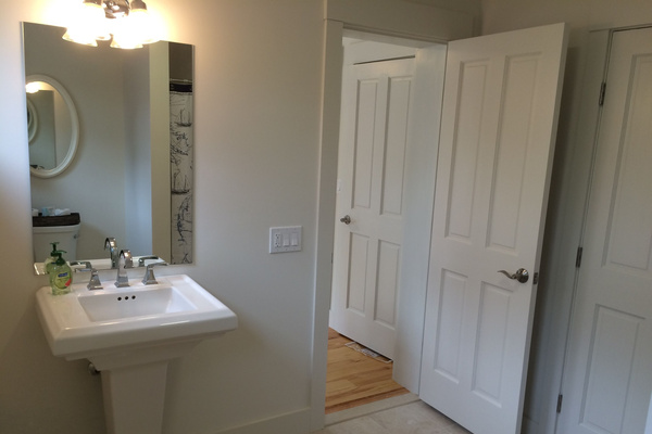 Bathroom off of room with three twin beds.
