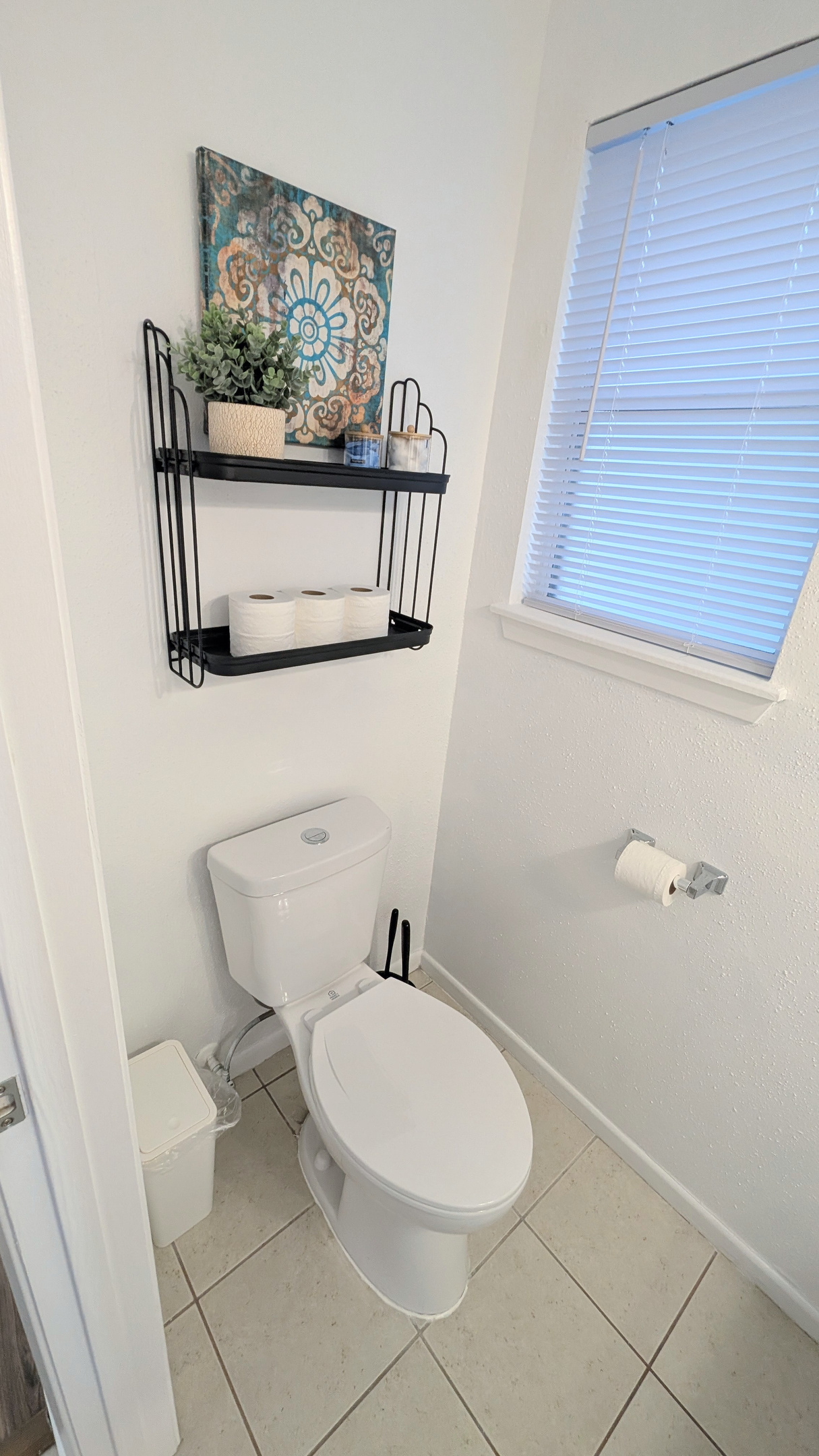 The half bath is well stocked with supplies conveniently within easy reach.