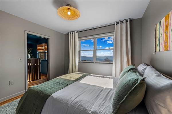 Another view of the queen bedroom, filled with natural light and mountain views—bright, calm, and easy to settle into.