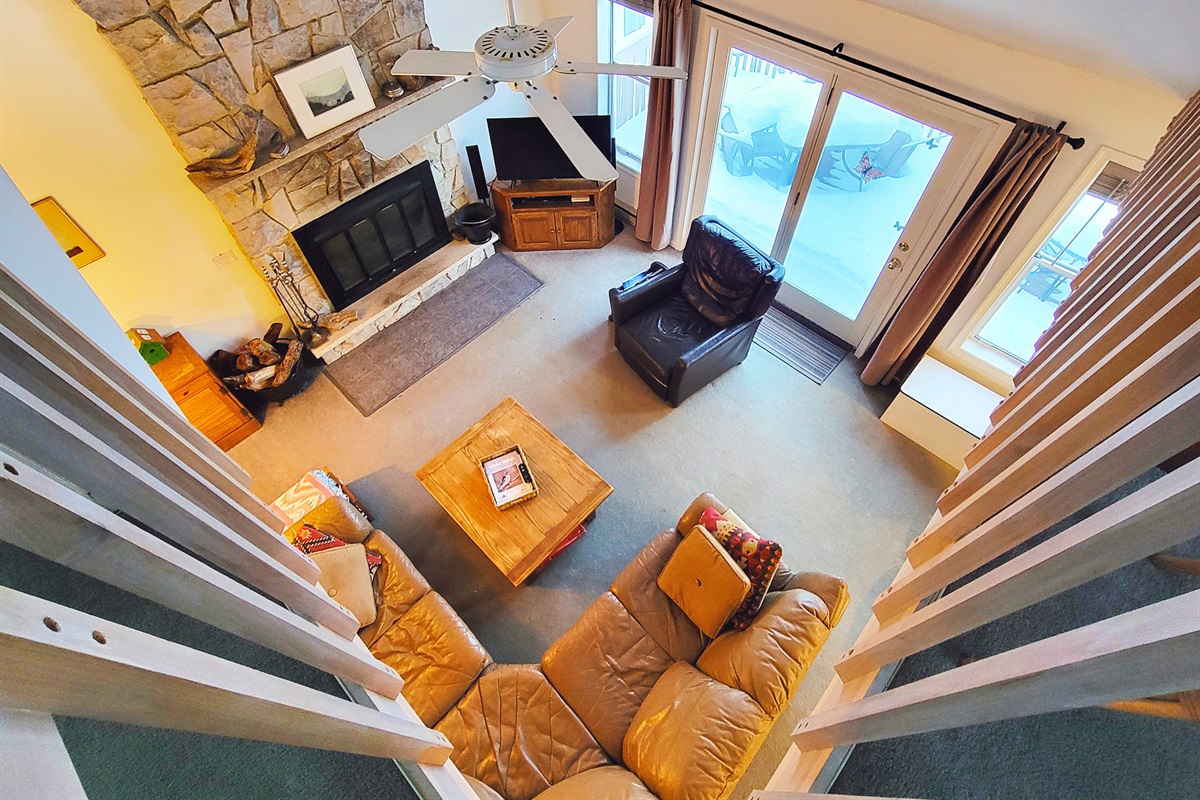 Sectional couch and TV next to fireplace in main living room